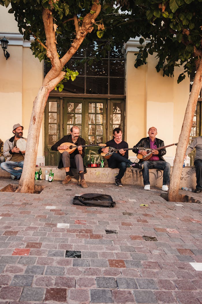 A group of adult men playing mandolins on the street, showcasing street performance art.