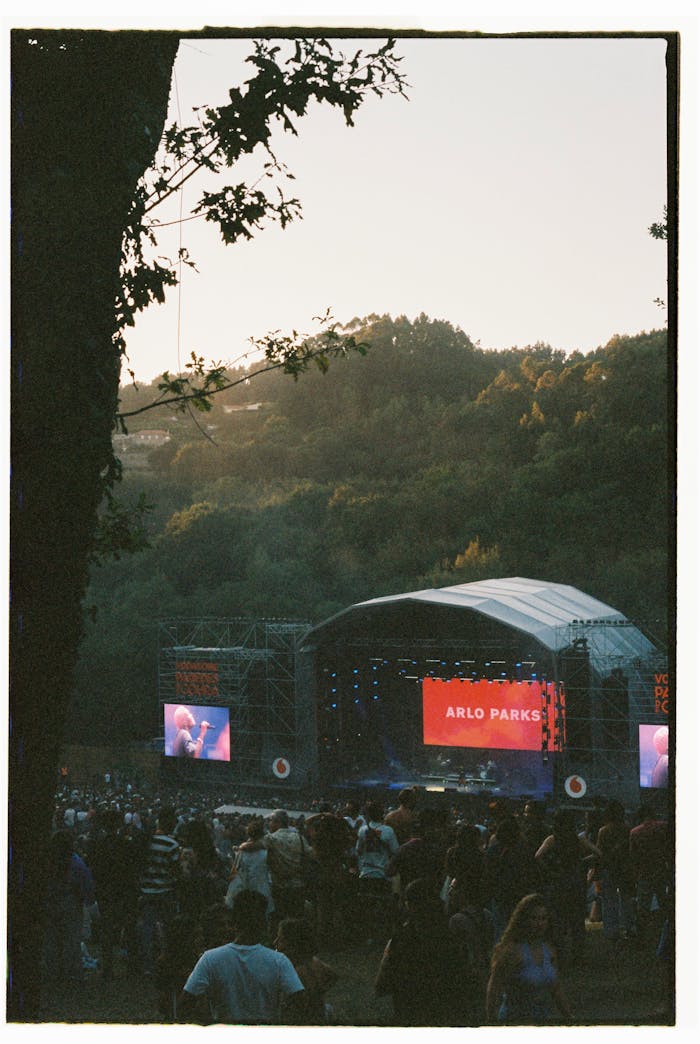 about-img Outdoor music concert at sunset in Coura, Portugal with crowd enjoying a live performance.