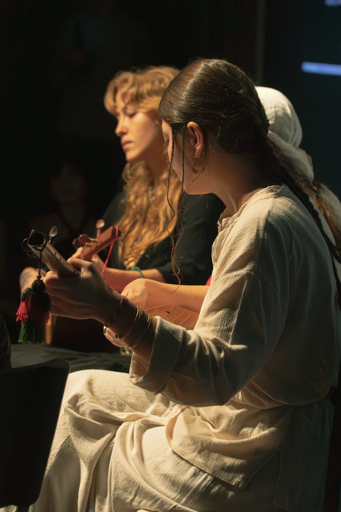 ours-journey Musicians performing acoustic guitar live on stage in moody lighting.