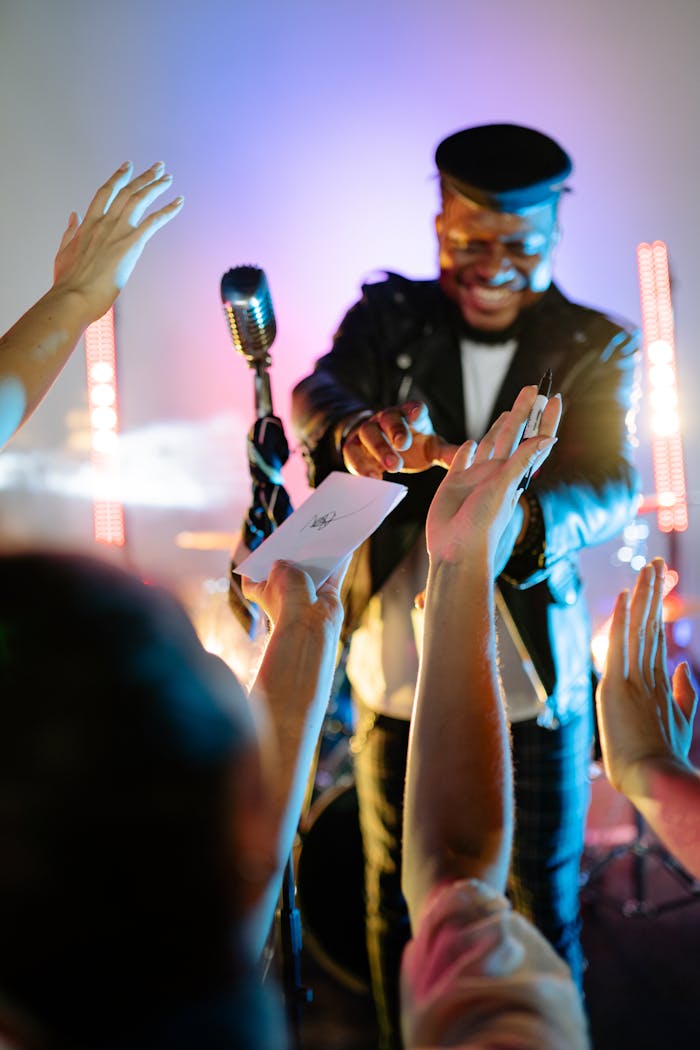 Singer interacting with fans during a vibrant concert performance.
