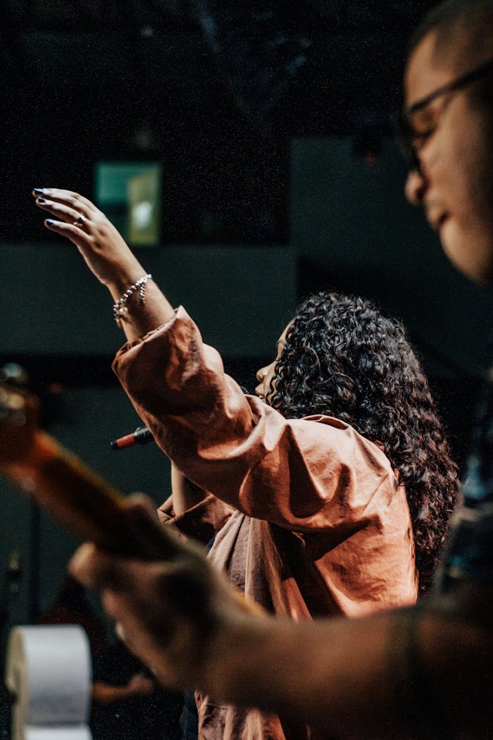 our-experience Dynamic live performance with a singer and guitarist, capturing the energy of a concert.